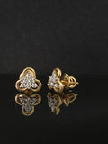 Pair of gold earrings with diamond accents 14K on black background
