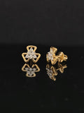 Pair of gold earrings with 0.23 carat diamonds on black background
