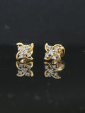 Pair of gold earrings with 0.2 carat diamonds 14K on black background
