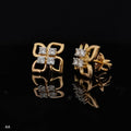 Pair of gold earrings with 0.31 carat diamonds 14K on black background
