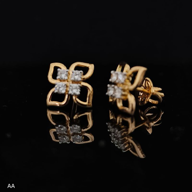 Pair of gold earrings with 0.31 carat diamonds 14K on black background
