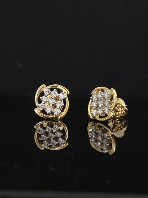 Pair of gold earrings with 0.33 carat diamonds on black background
