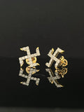 Pair of gold earrings with 0.56 carat diamonds 14K on black background
