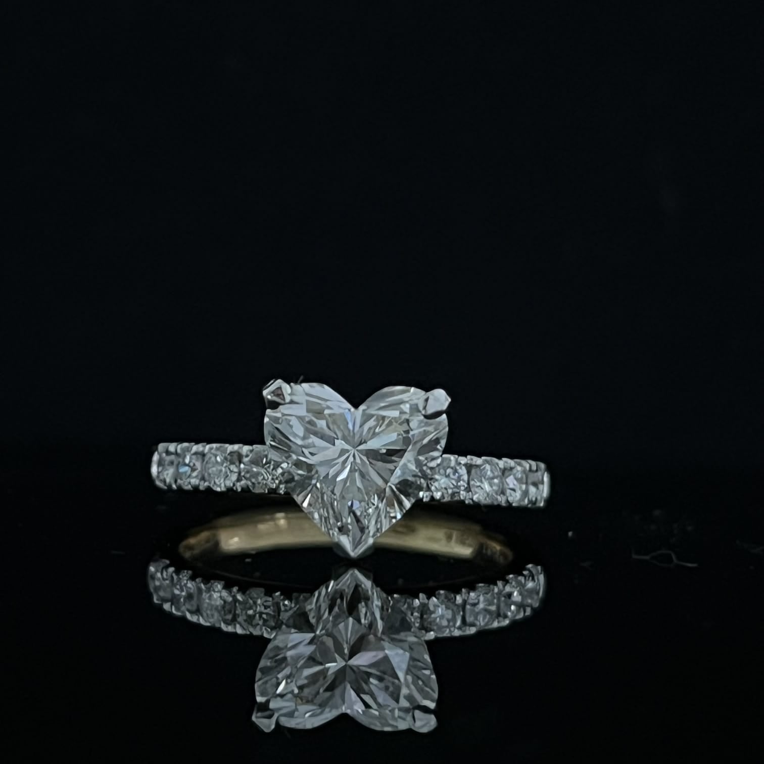 Gold ring with 1.92 carat diamond stone on reflective surface
