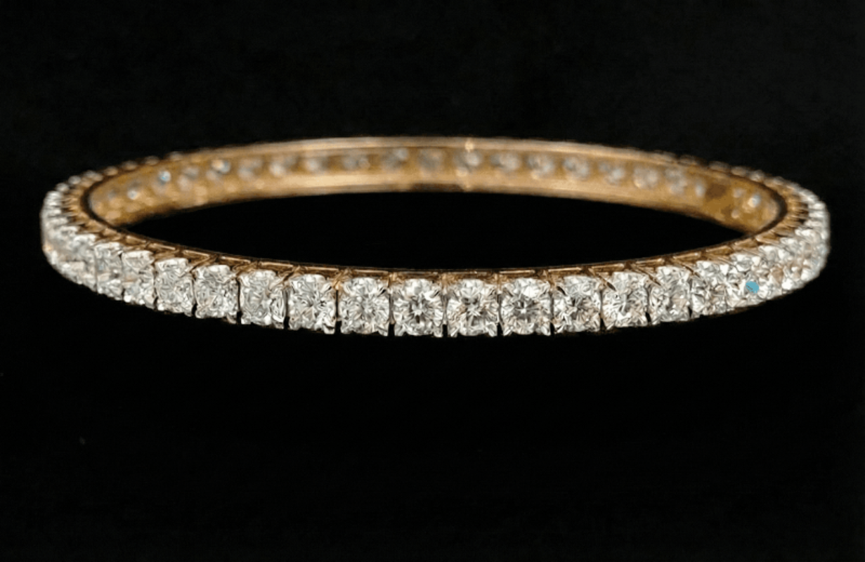 10.27 carat round shaped diamond bangle in 18K gold on black background
