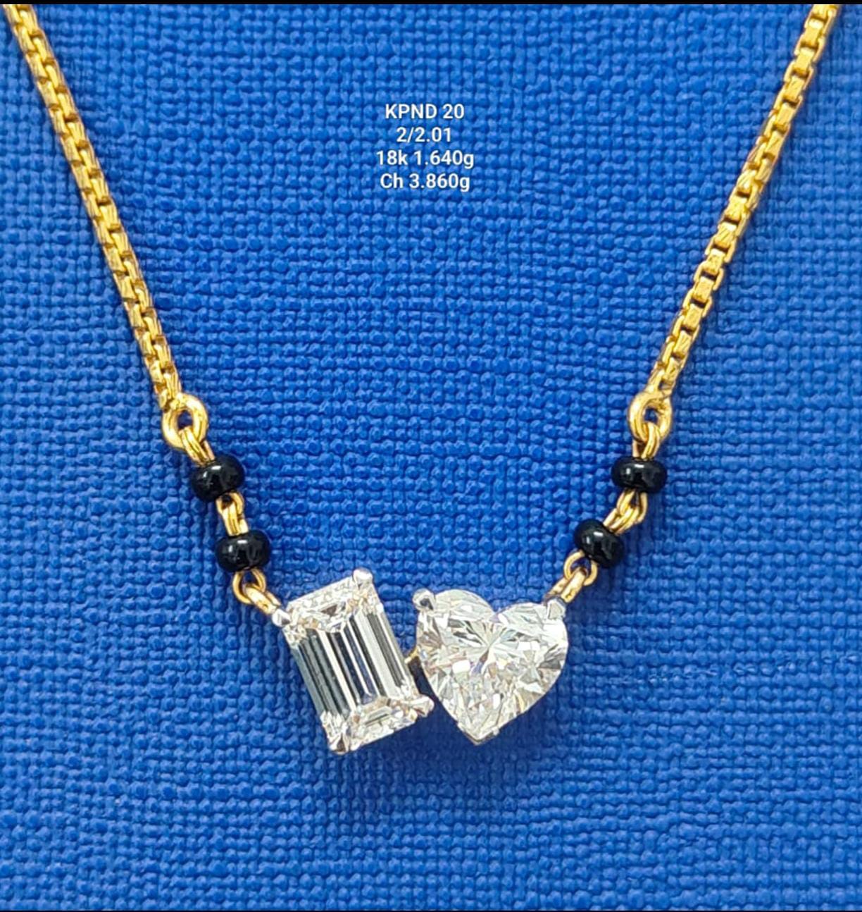 Diamond pendant in 18K gold with modern design on blue background
