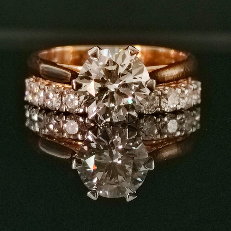 Gold ring with 2.16 carat diamond stone on reflective surface

