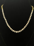 Elegant gold necklace with multiple diamond stones 14K purity on black background
