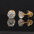 Pair of gold earrings with 3.05 carat diamonds 18K on black background
