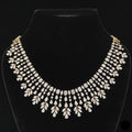 39.02 carat round and fancy shaped diamond necklace in 14K gold on black background
