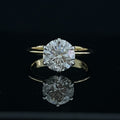 Gold ring with a large diamond on a black background