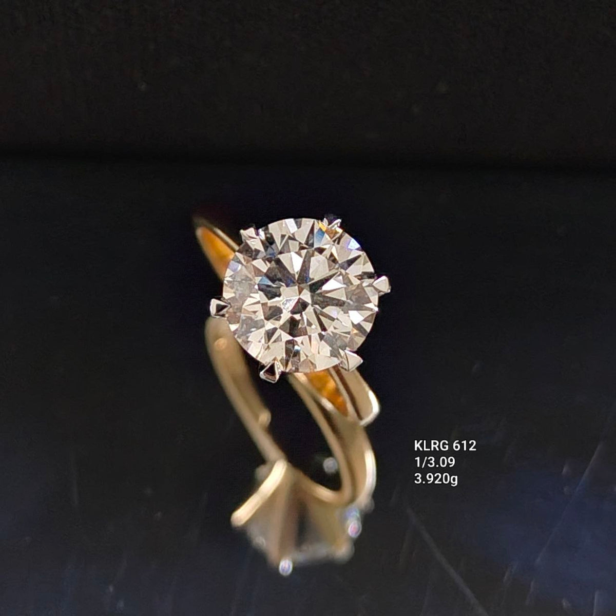 3.09 carat round lab grown diamond solitaire ring in 18K yellow gold with white-toned claws