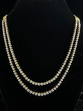 Two-layered pearl necklace on a black stand