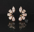 Diamond earrings on a black reflective surface
