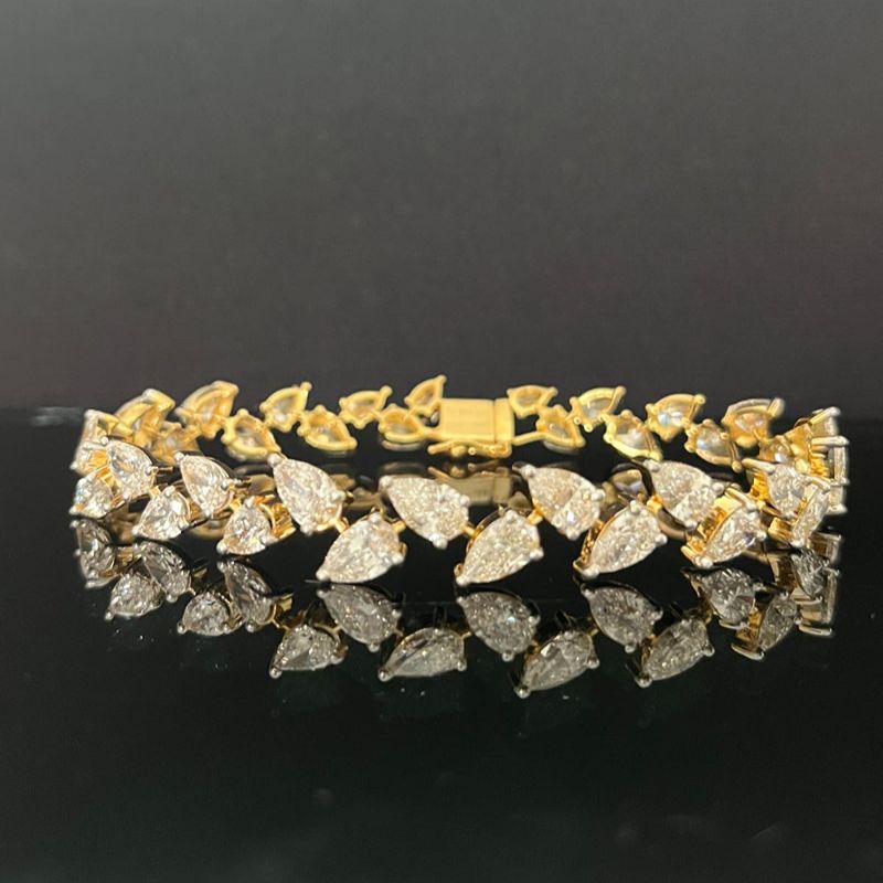 Gold and diamond bracelet on a black background