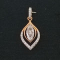Diamond pendant with gold and silver accents on black background
