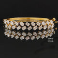 4.69 carat emerald cut and oval lab grown diamond bangle bracelet in 14K yellow gold with white-toned claws