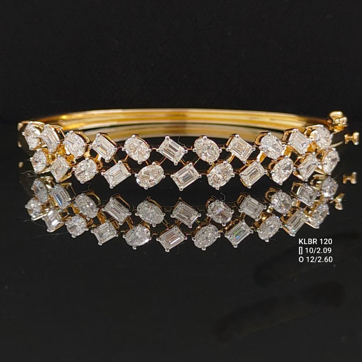 4.69 carat emerald cut and oval lab grown diamond bangle bracelet in 14K yellow gold with white-toned claws